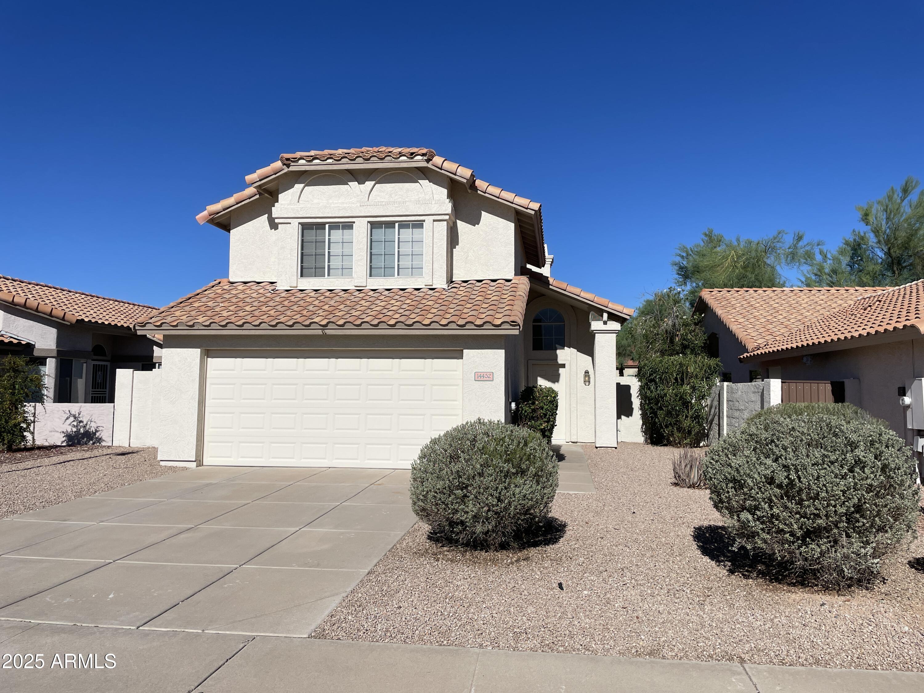 14452 South 43rd Street Phoenix, AZ 85044 - Photo 2 of 33 a front view of a house with a garage