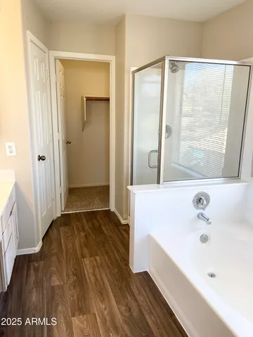 a spacious bathroom with a double vanity sink and a large mirror