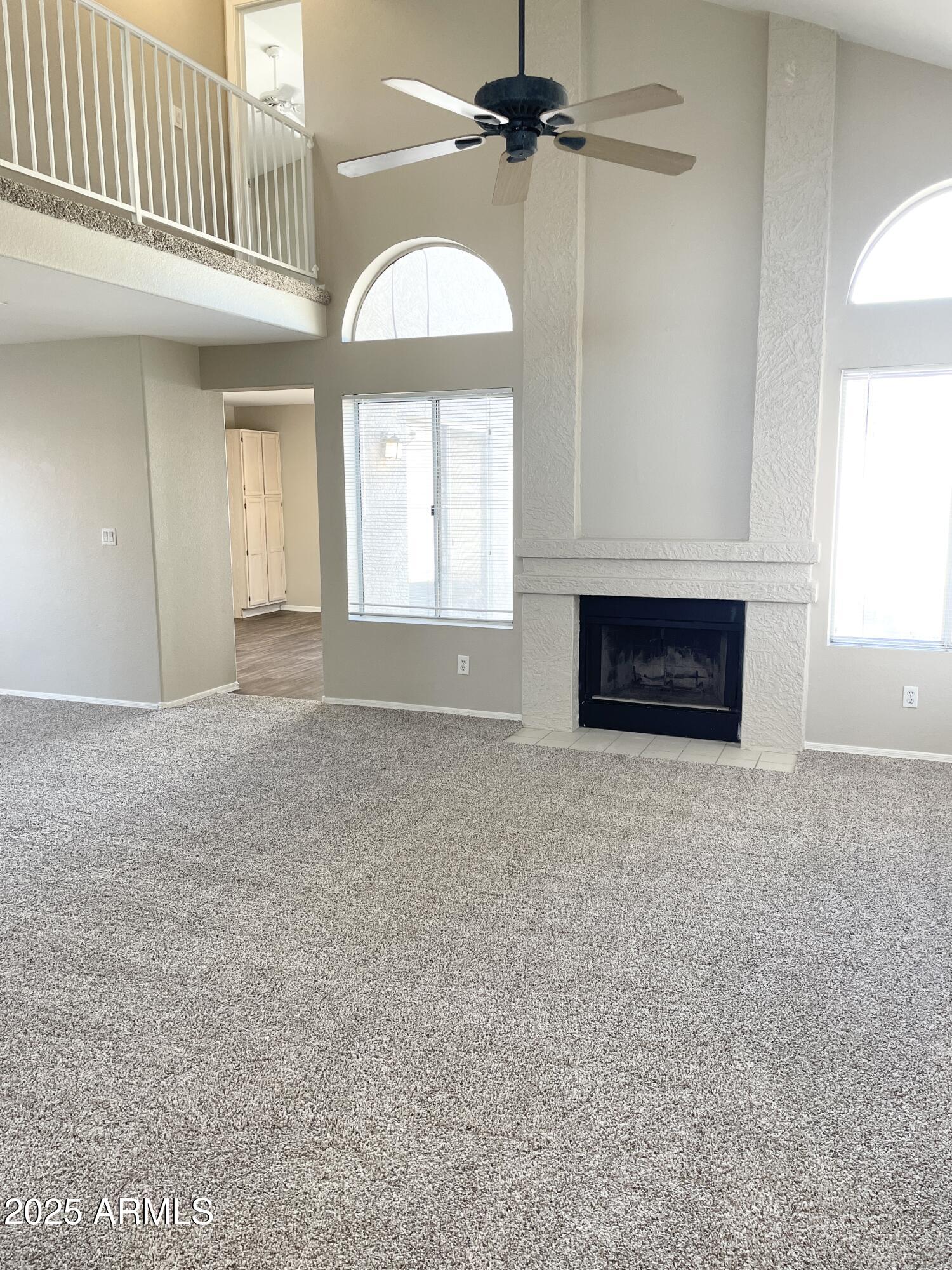 14452 South 43rd Street Phoenix, AZ 85044 - Photo 4 of 33 an empty room with windows and fireplace