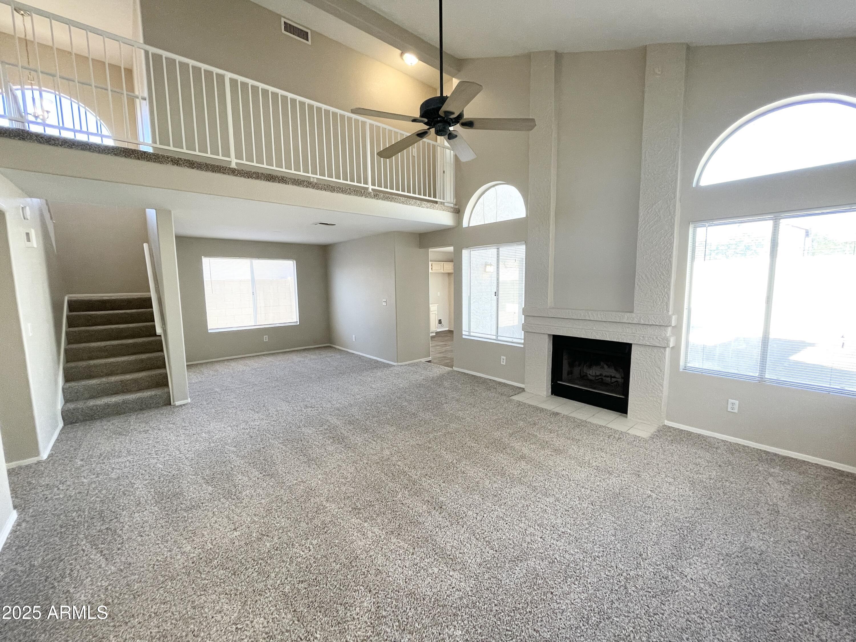 14452 South 43rd Street Phoenix, AZ 85044 - Photo 5 of 33 a view of an empty room with a fireplace and a window