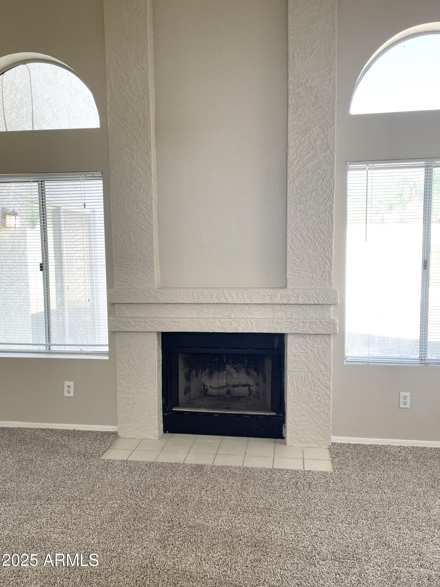 14452 South 43rd Street Phoenix, AZ 85044 - Photo 7 of 33 an empty room with windows and fireplace