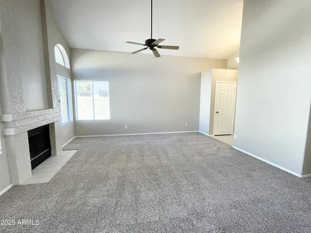 a view of a livingroom with a fireplace and window