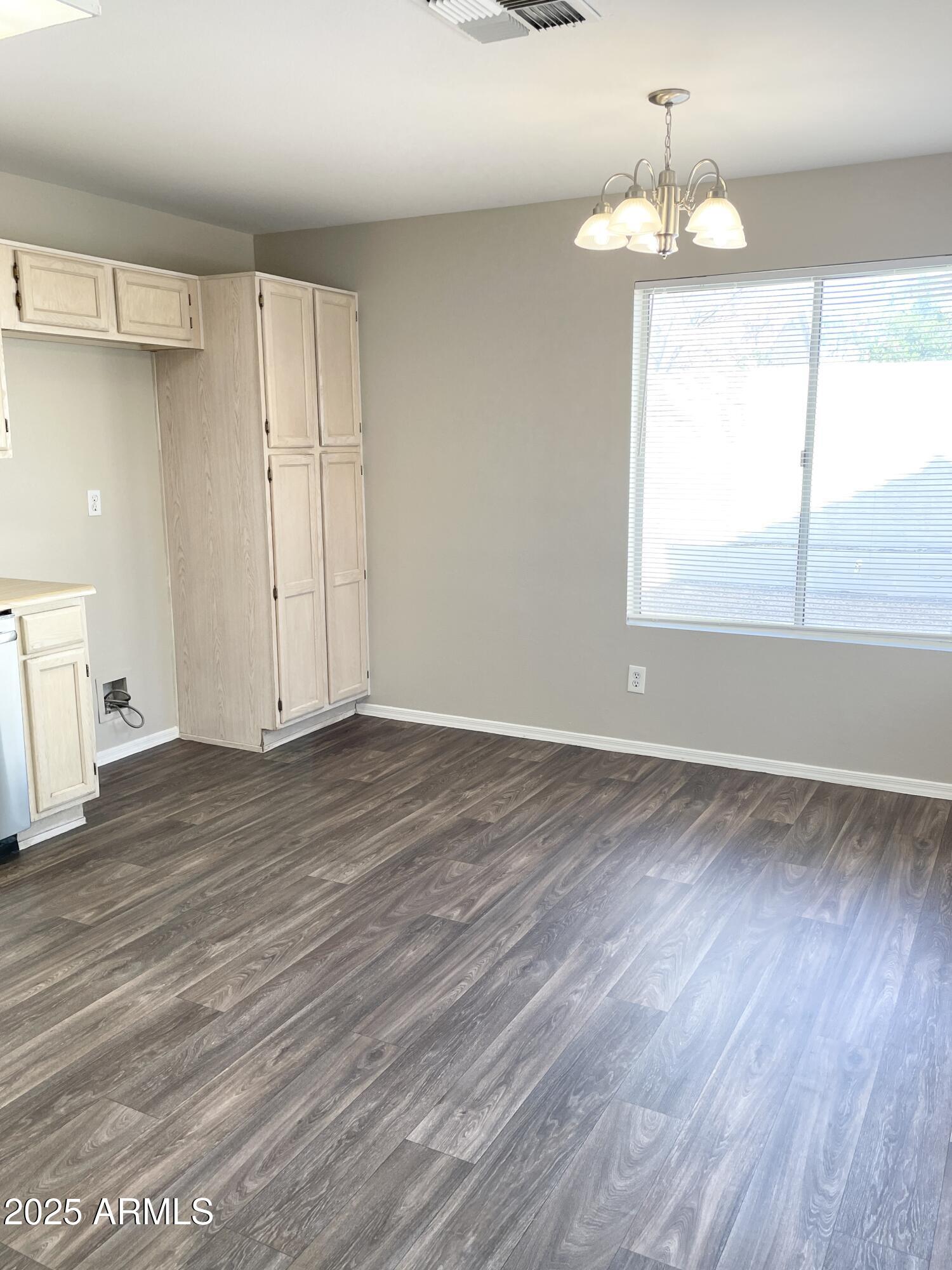 14452 South 43rd Street Phoenix, AZ 85044 - Photo 9 of 33 an empty room with wooden floor and windows
