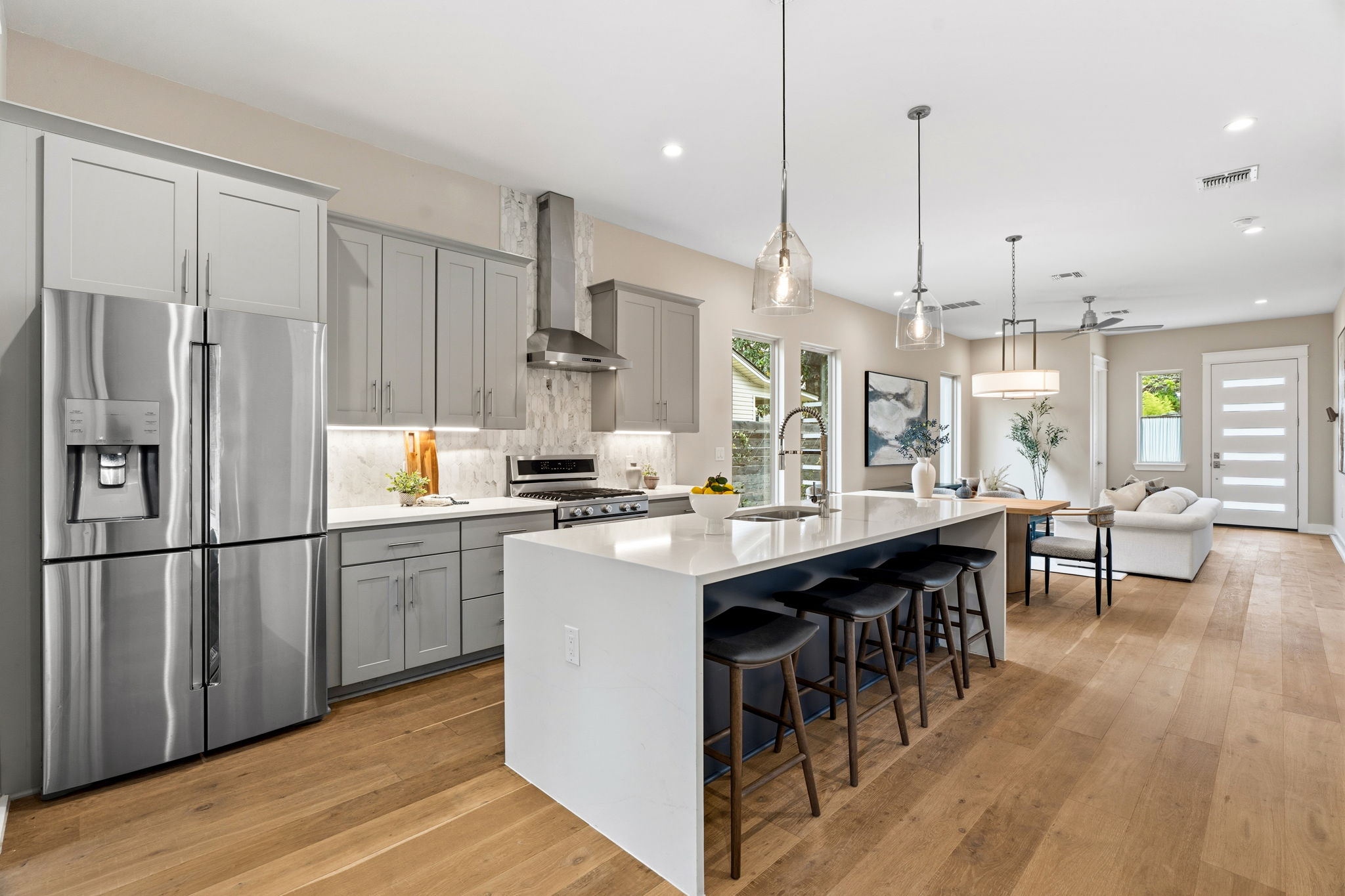 1409 Alegria Road, Unit B Austin, TX 78757 - Photo 13 of 39 a kitchen with stainless steel appliances granite countertop a refrigerator a sink dishwasher a stove a dining table and chairs with wooden floor