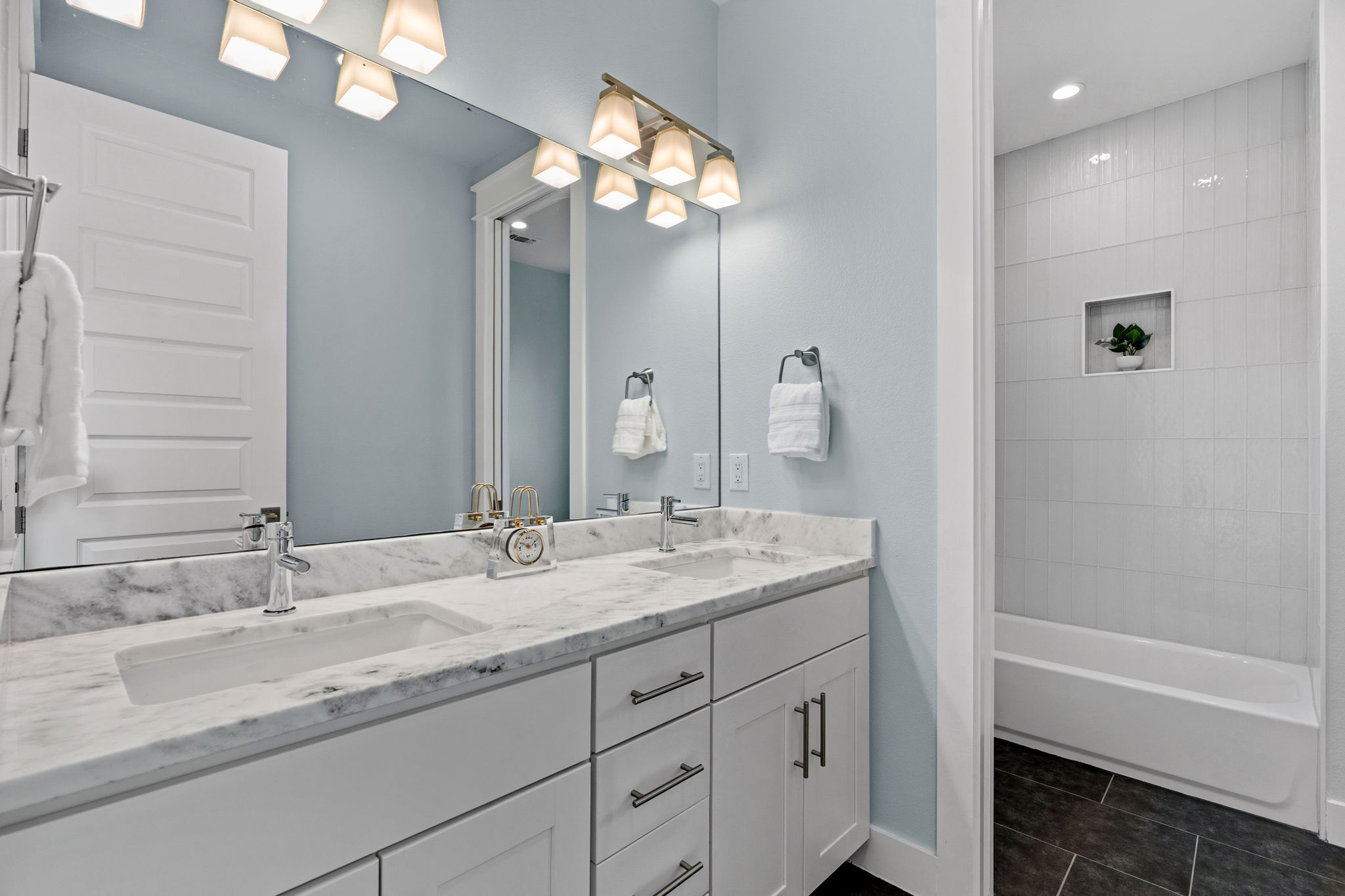 1409 Alegria Road, Unit B Austin, TX 78757 - Photo 27 of 39 a bathroom with a granite countertop sink a large mirror and a bathtub