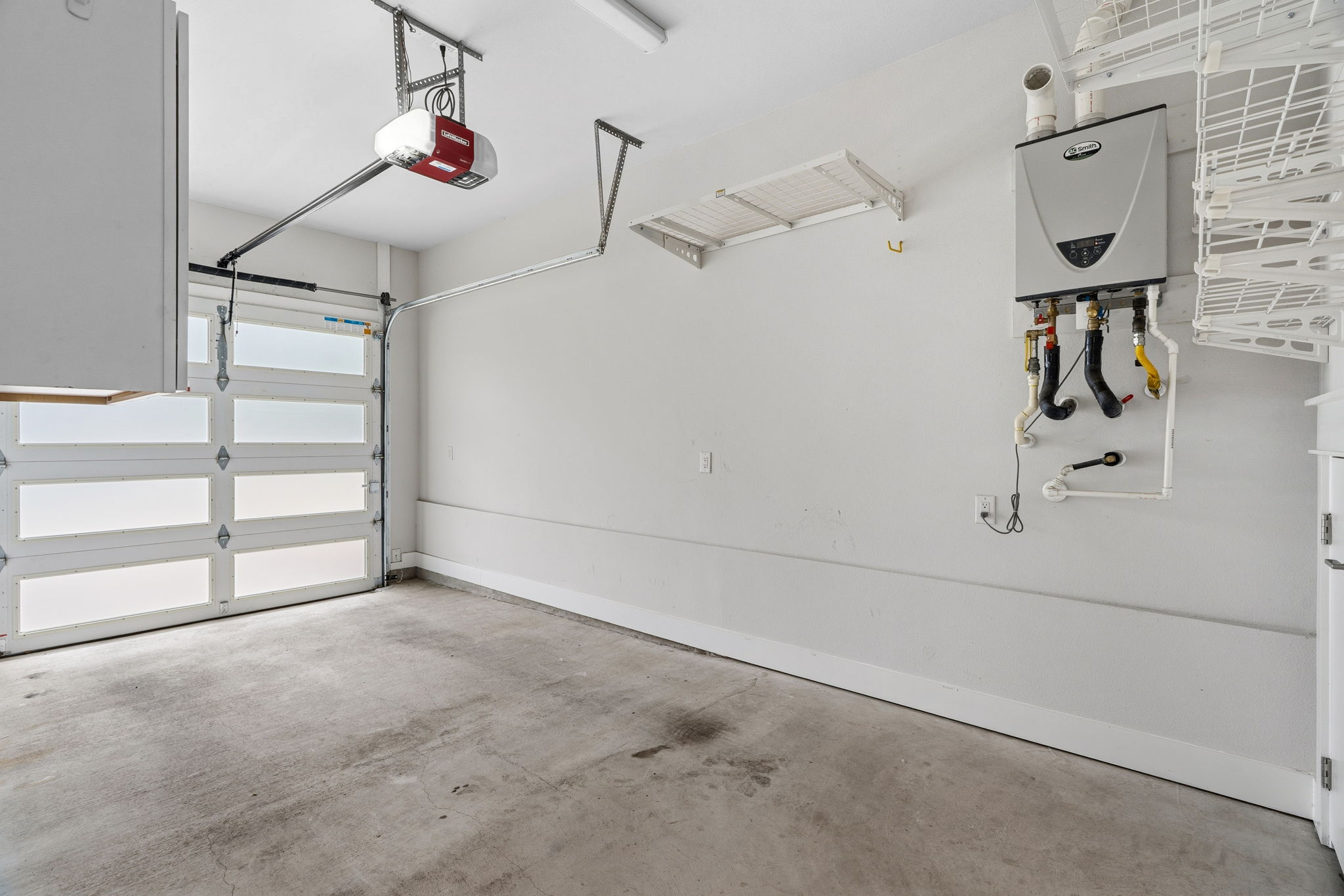 1409 Alegria Road, Unit B Austin, TX 78757 - Photo 29 of 39 Garage with large storage closet, shelving, and automatic opener.