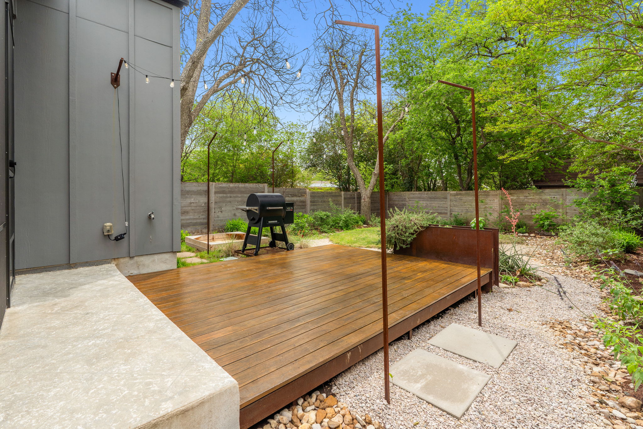 1409 Alegria Road, Unit B Austin, TX 78757 - Photo 31 of 39 Extended wood deck with metal grate grill stand, & raised garden bed.