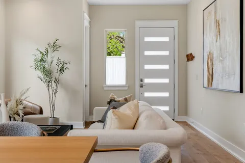 a living room with a sink furniture and a large window