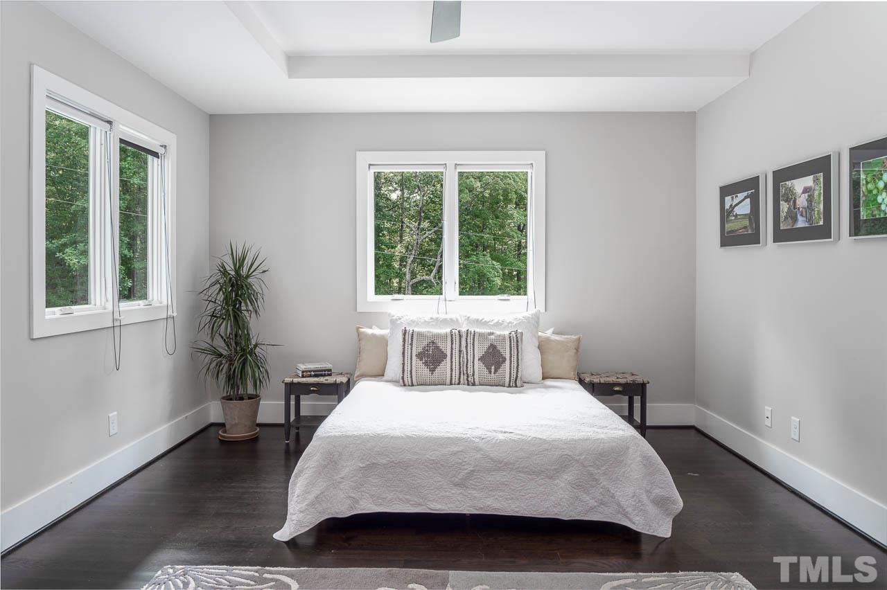 384 Booth Road Chapel Hill, NC 27516 - Photo 11 of 30 a bedroom with a large bed and a window