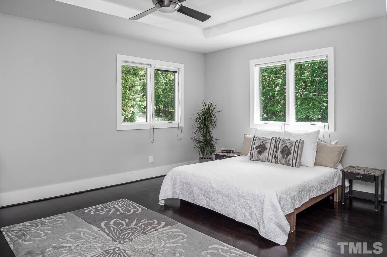 384 Booth Road Chapel Hill, NC 27516 - Photo 12 of 30 a bedroom with a large bed and a window