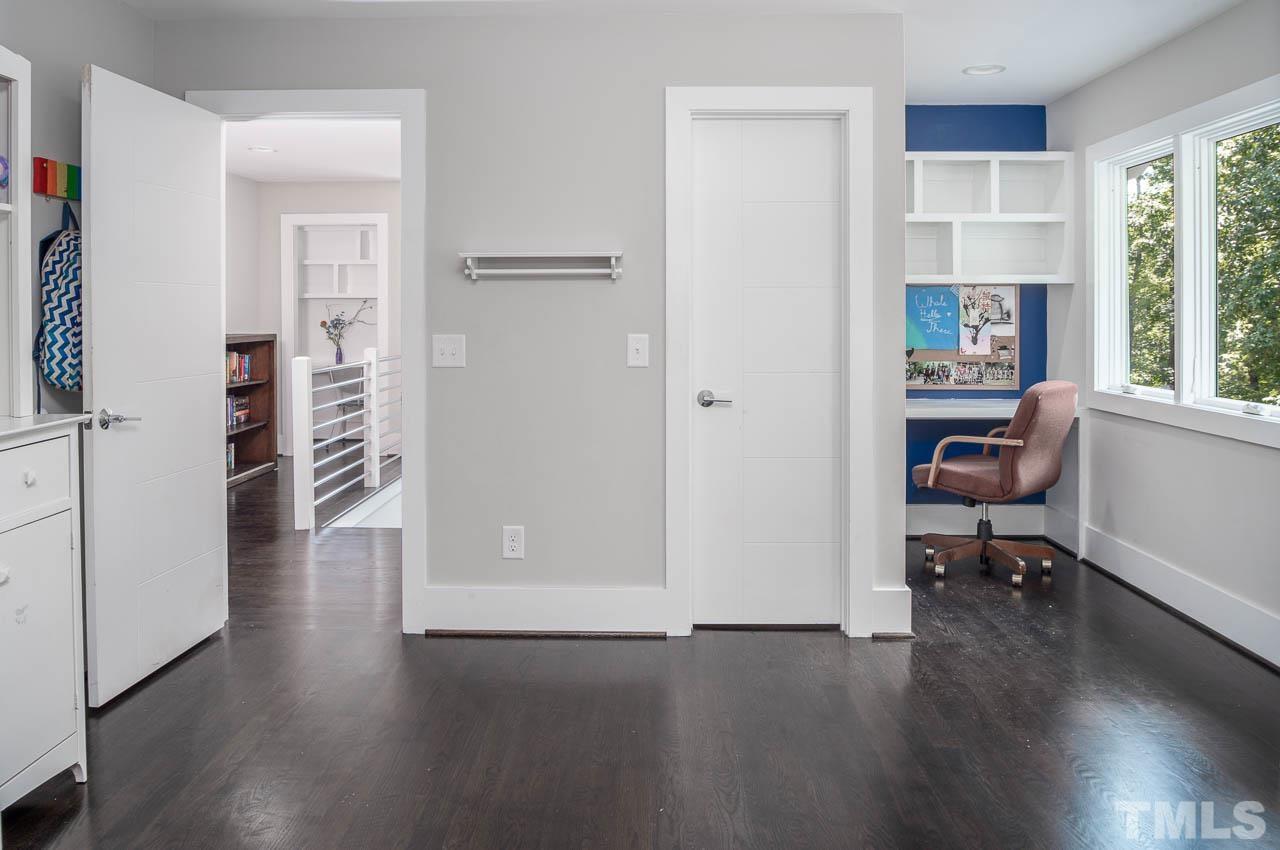 384 Booth Road Chapel Hill, NC 27516 - Photo 18 of 30 a view of a workspace with wooden floor and a window