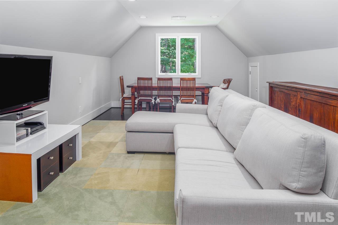 384 Booth Road Chapel Hill, NC 27516 - Photo 21 of 30 a living room with furniture and a flat screen tv