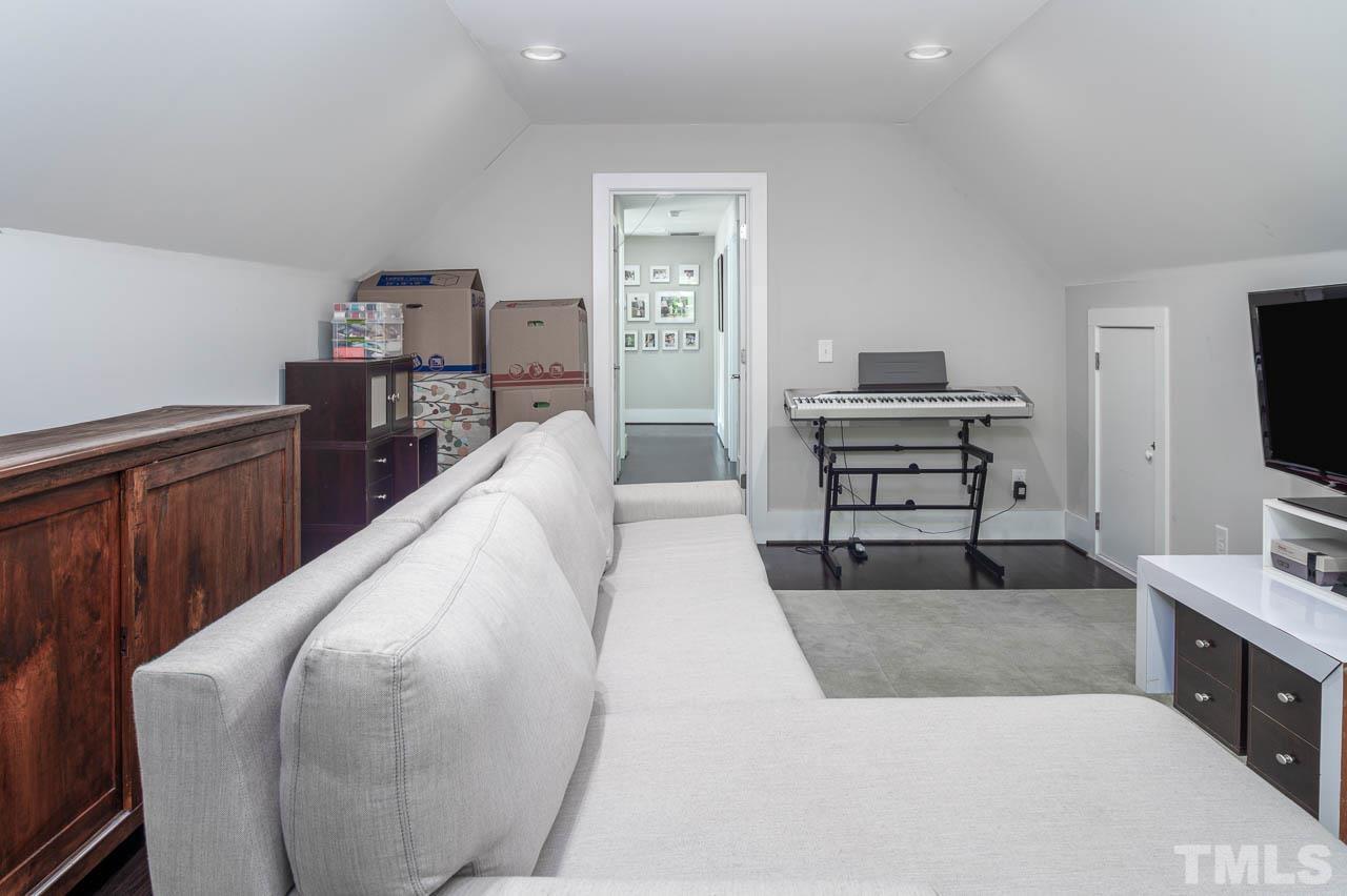 384 Booth Road Chapel Hill, NC 27516 - Photo 22 of 30 a living room with furniture and a flat screen tv