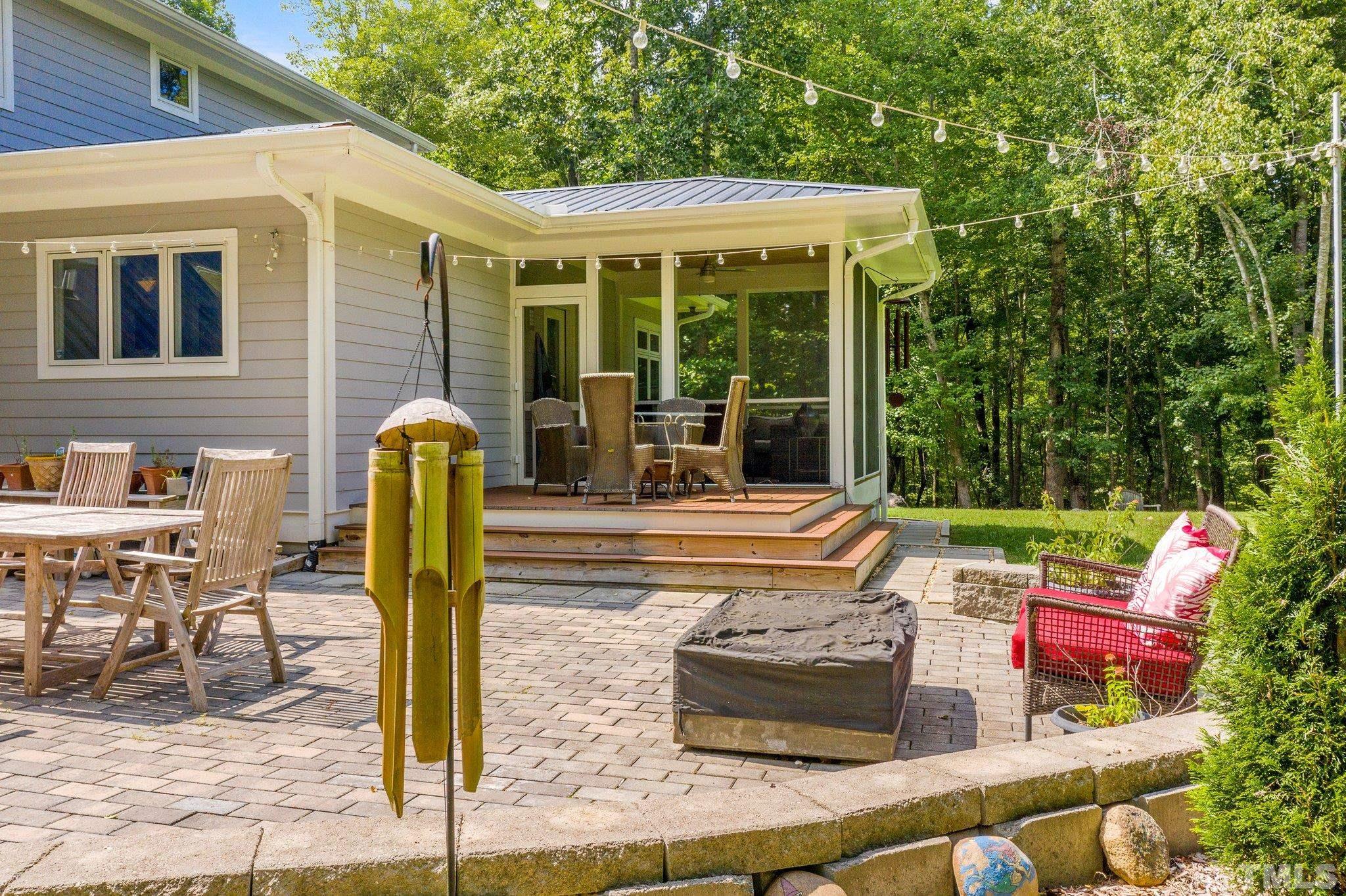 384 Booth Road Chapel Hill, NC 27516 - Photo 27 of 30 a view of a patio with table and chairs and potted plants