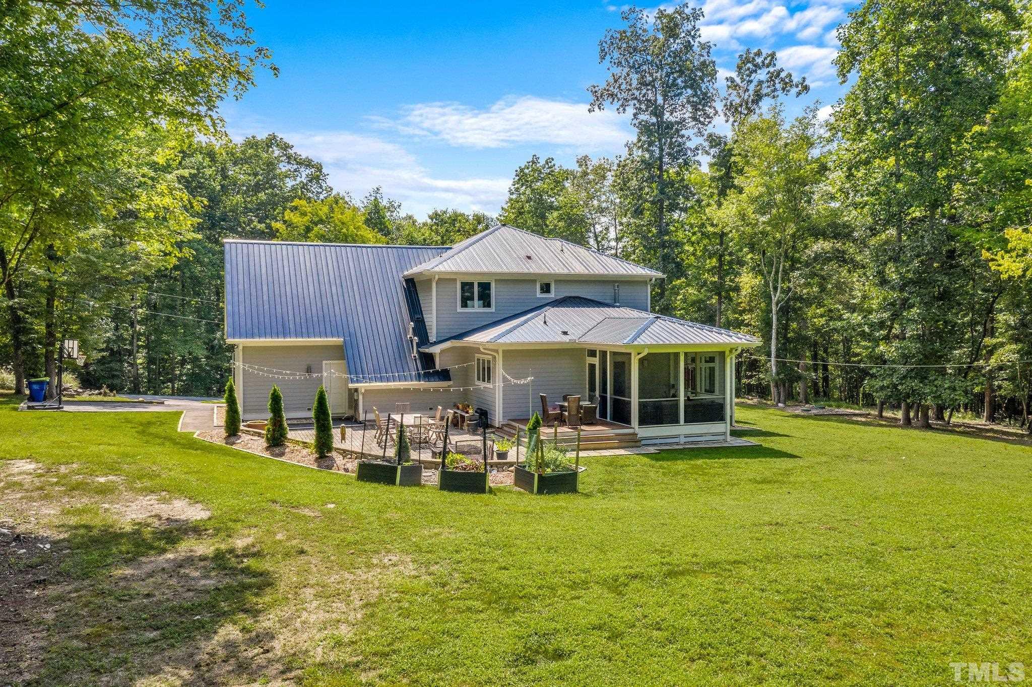 384 Booth Road Chapel Hill, NC 27516 - Photo 28 of 30 a patio with wooden table and chairs