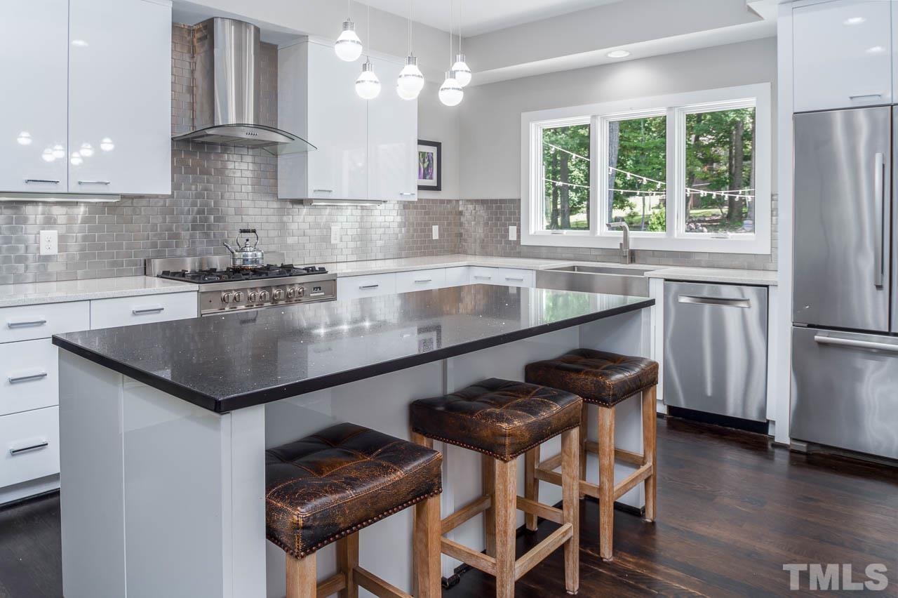 384 Booth Road Chapel Hill, NC 27516 - Photo 9 of 30 a kitchen with a center island appliances and cabinets