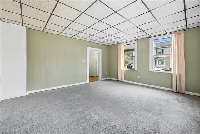 a view of a hallway with a window and stairs