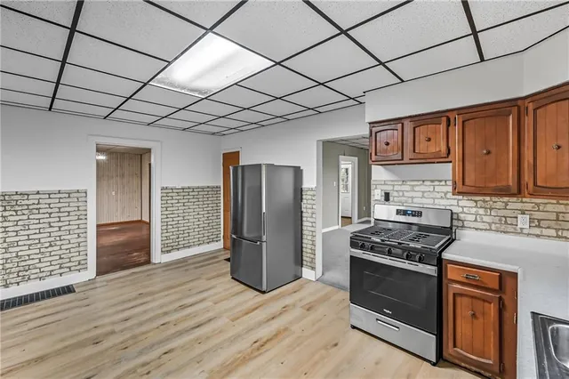 a kitchen with stainless steel appliances granite countertop a refrigerator sink and cabinets