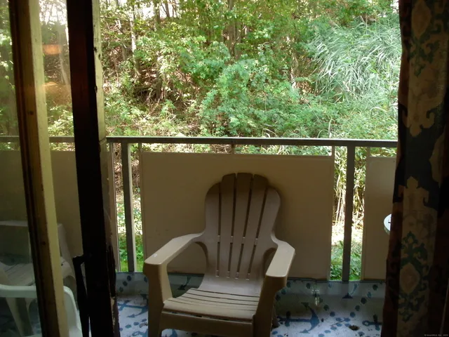 a kitchen with granite countertop a sink a stove and cabinets