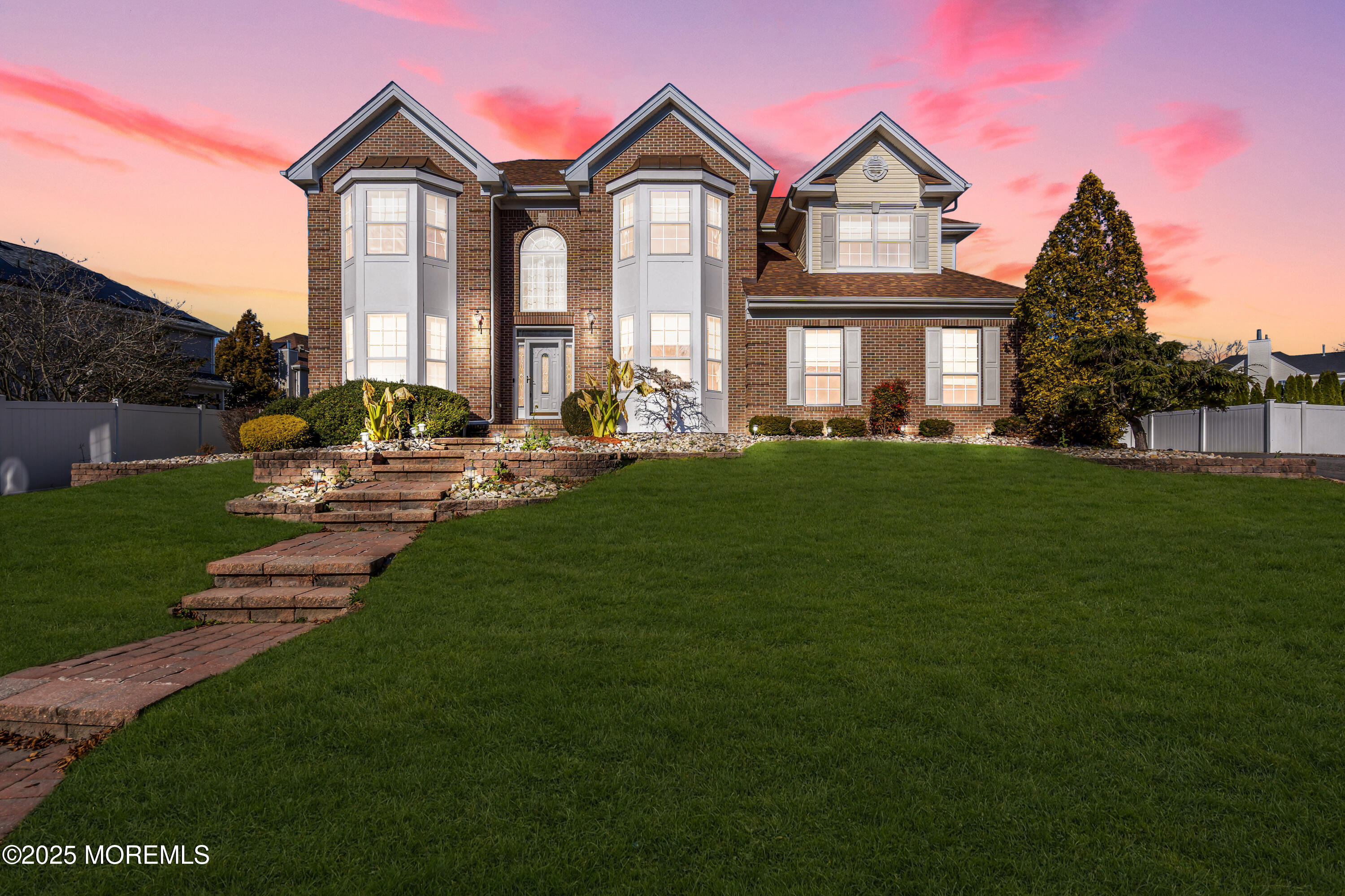 a front view of a house with a garden