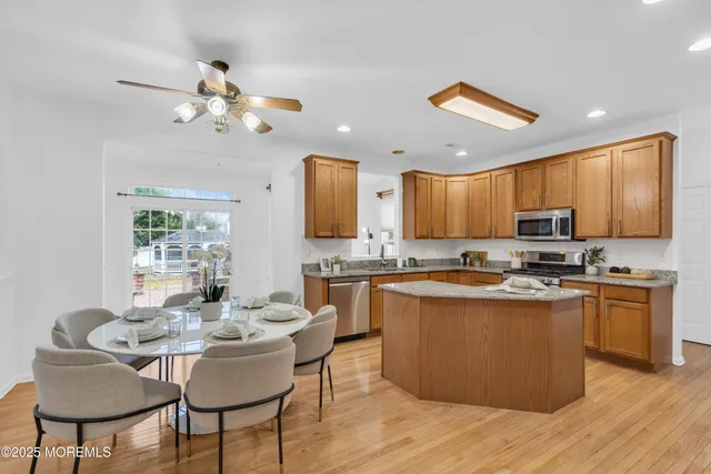 a kitchen with kitchen island a dining table and chairs