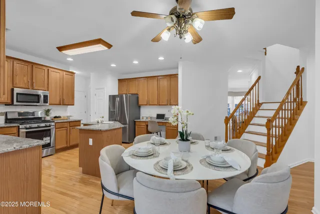 a view of a dining room with furniture a kitchen and chandelier