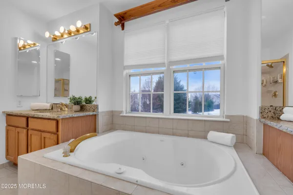 a white bath tub sitting in a bathroom next to a window