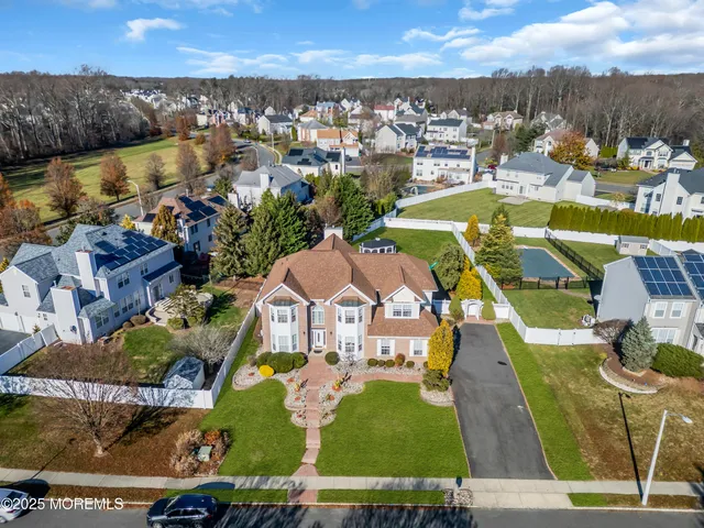 an aerial view of residential houses with outdoor space and swimming pool
