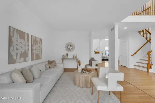 a living room with furniture and wooden floor