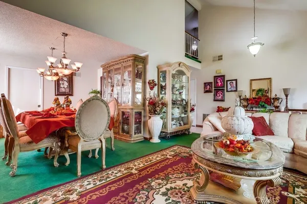 a view of a dining room with furniture and chandelier