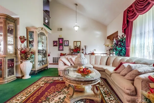 a living room with furniture and a chandelier