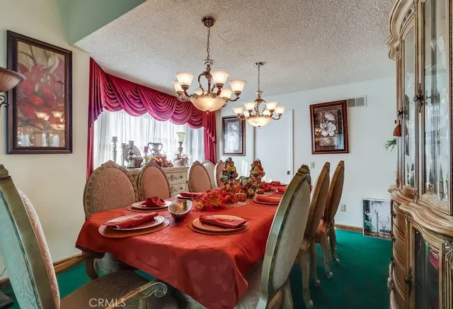 a kitchen with stainless steel appliances granite countertop a refrigerator and a stove