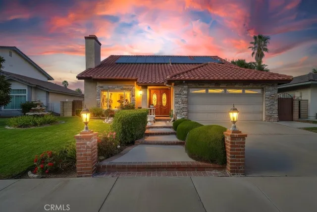a front view of a house with garden
