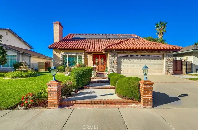 a front view of a house with garden