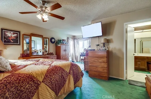 a bedroom with bed and a flat tv screen