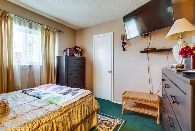 a bedroom with a bed and dresser