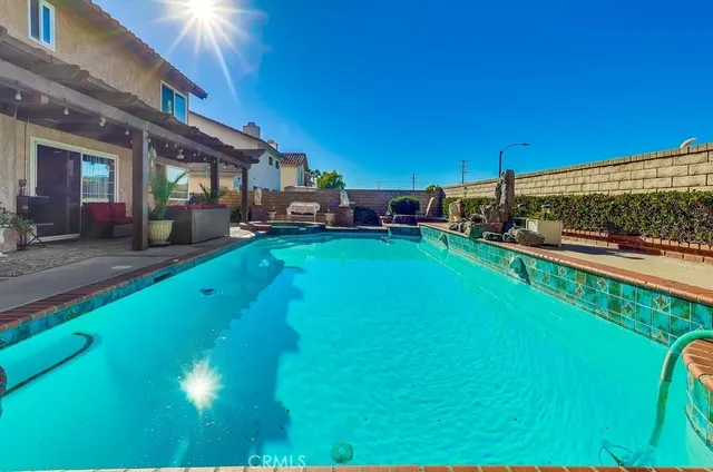 a view of a house with a yard patio and fire pit