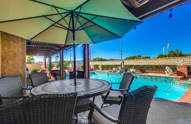 a view of a patio with couches chairs and a potted plant