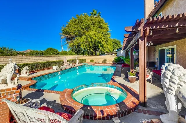 a view of a backyard with swimming pool