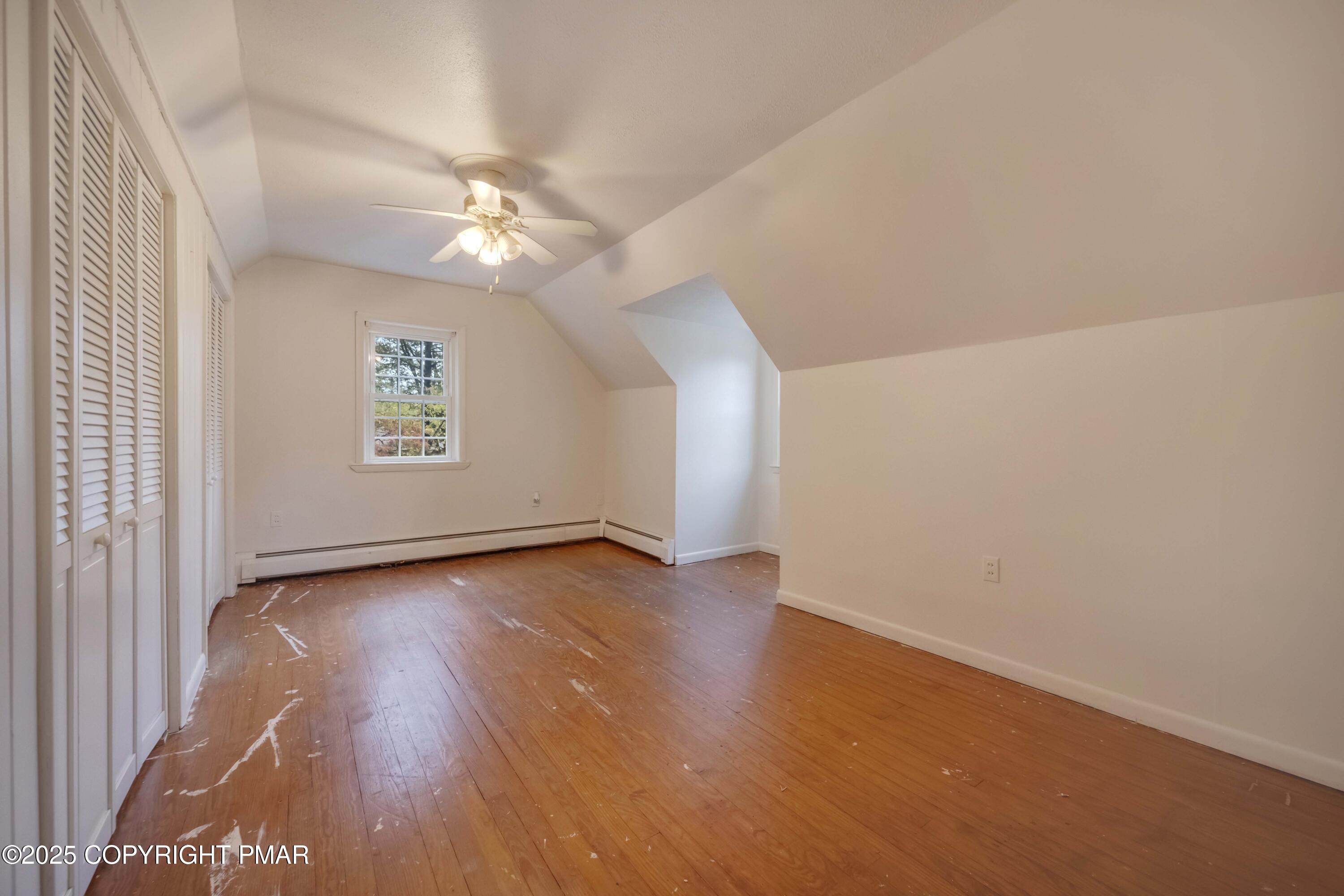 2917 Long Pond Road Long Pond, PA 18334 - Photo 20 of 30 an empty room with wooden floor chandelier fan and windows