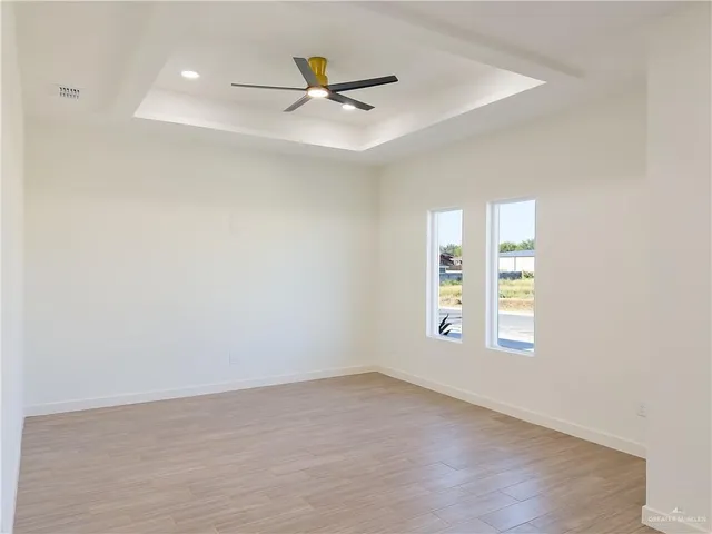 a view of a livingroom with a ceiling fan and window