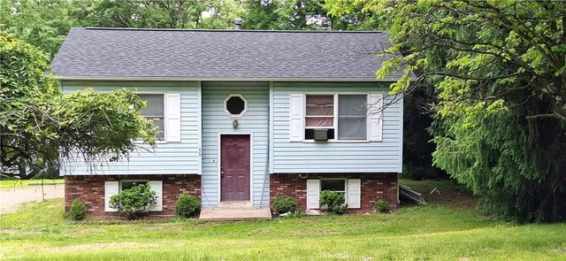 a front view of a house with a garden