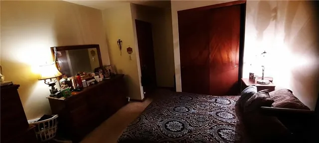 a bedroom with a bed and a mirror