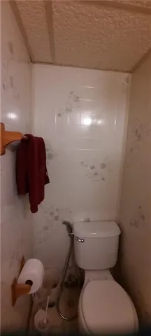 a white toilet sitting next to a bathroom sink