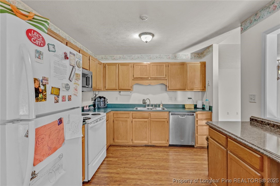317 Kernstown Road Raeford, NC 28376 - Photo 17 of 32 a kitchen with stainless steel appliances granite countertop a stove and a sink