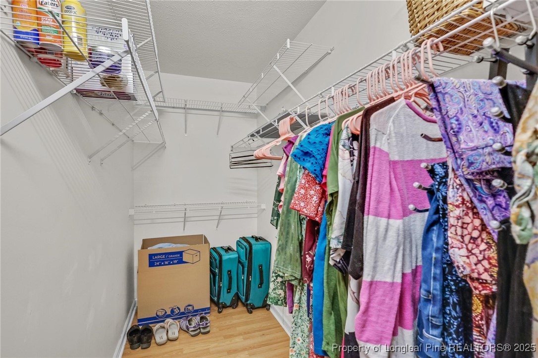 317 Kernstown Road Raeford, NC 28376 - Photo 23 of 32 a view of walk in closet with clothes and shoes