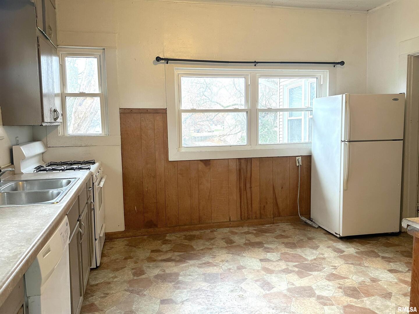405 West College Street Carbondale, IL 62901 - Photo 5 of 18 a kitchen with a refrigerator sink stove and cabinets