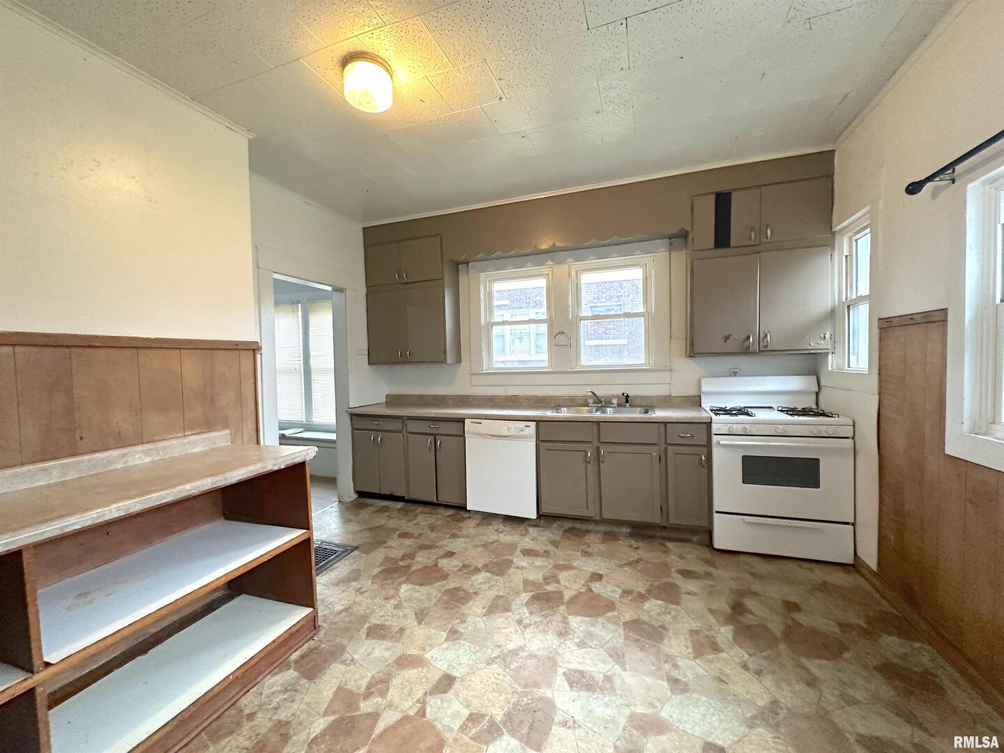 405 West College Street Carbondale, IL 62901 - Photo 7 of 18 a kitchen with granite countertop white cabinets and white appliances