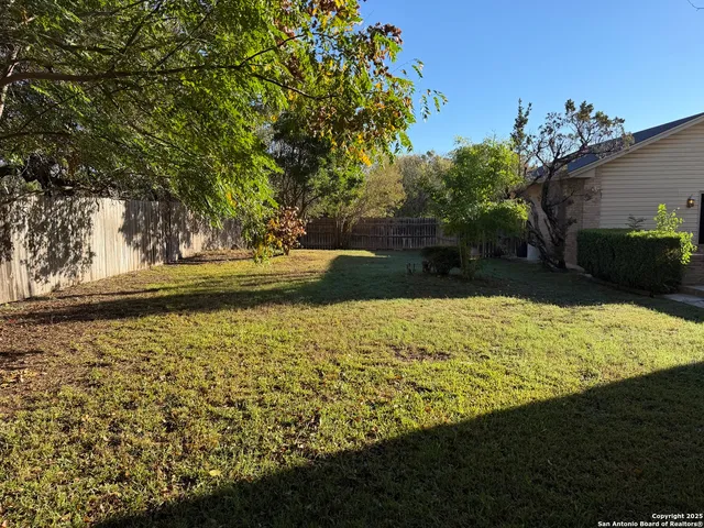 a view of backyard with swimming pool