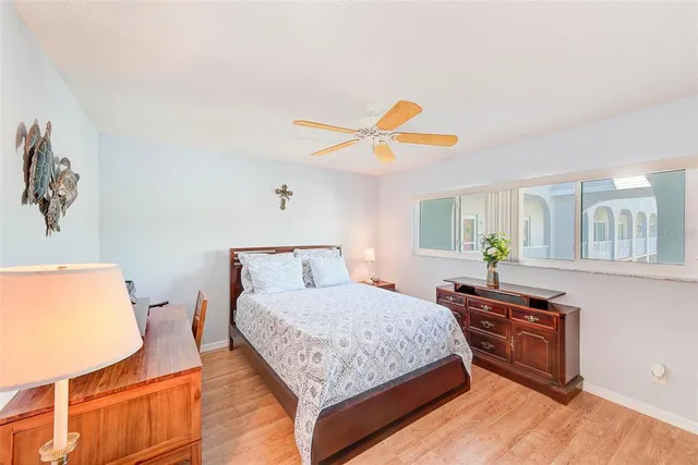 a bedroom with a bed window and a table